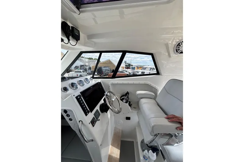 Slide: The Image of Interior of a 2020 Protector 380 Targa boat with modern dashboard and seating. - 28