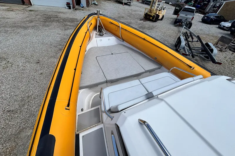 Slide: The Image of 2020 Protector 380 Targa boat with yellow inflatable sides, docked on gravel. - 5