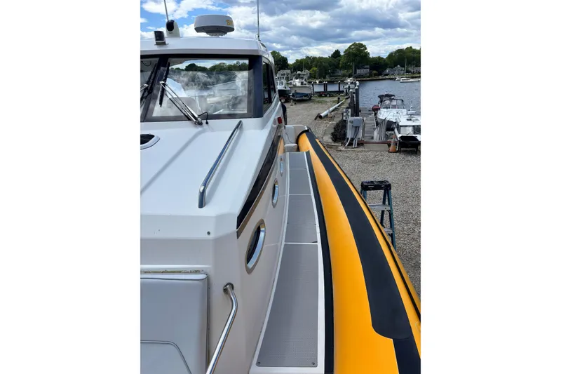 Slide: The Image of 2020 Protector 380 Targa boat docked, featuring sleek design and vibrant yellow accents. - 7
