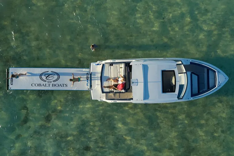 Slide: The Image of Manufacturer Provided Image: 2025 Cobalt A29 boat with extended swim platform in clear water, aerial view. - 4