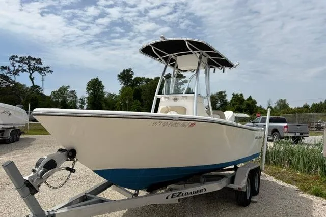 Slide: The Image of 2019 Sea Born LX21 Center Console boat on trailer, parked outdoors under a cloudy sky. - 1