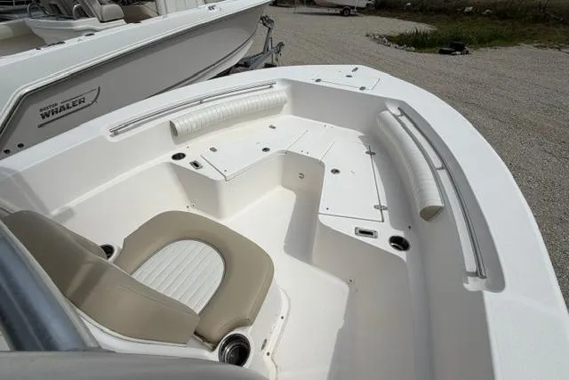 Slide: The Image of 2019 Sea Born LX21 Center Console boat interior with seating and storage compartments. - 12
