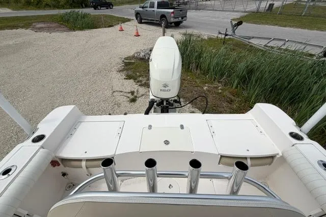Slide: The Image of 2019 Sea Born LX21 Center Console boat with Suzuki outboard motor, parked on gravel. - 13