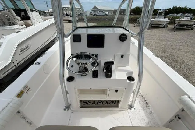 Slide: The Image of 2019 Sea Born LX21 Center Console boat interior with steering wheel and controls. - 16