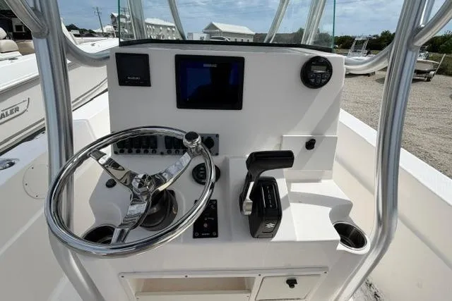 Slide: The Image of 2019 Sea Born LX21 Center Console boat dashboard with steering wheel and controls. - 17