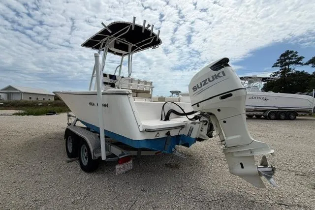 Slide: The Image of 2019 Sea Born LX21 Center Console boat with Suzuki outboard motor on a trailer. - 2