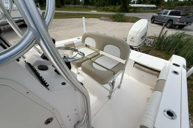 Slide: The Image of 2019 Sea Born LX21 Center Console boat interior with seating and steering wheel. - 5