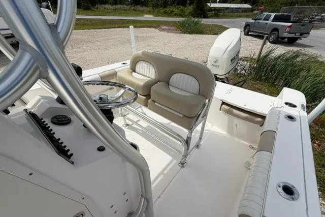 Slide: The Image of 2019 Sea Born LX21 Center Console boat with seating and steering wheel, parked outdoors. - 6