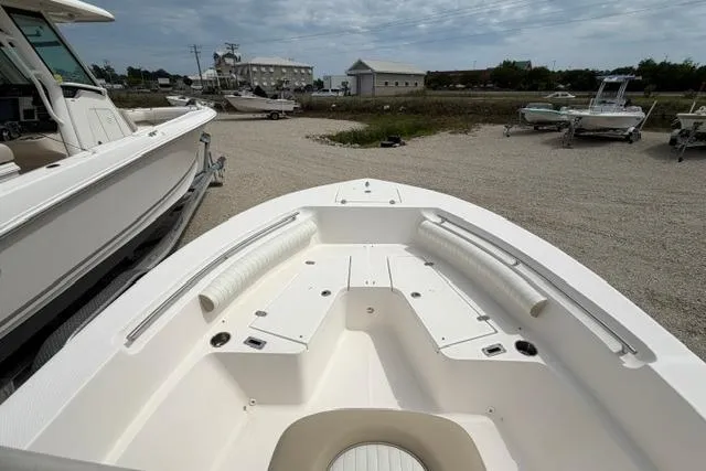 Slide: The Image of 2019 Sea Born LX21 Center Console boat, white interior, parked outdoors on gravel. - 8