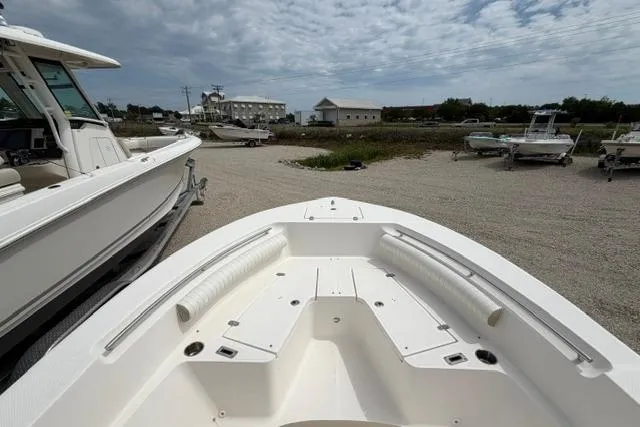 Slide: The Image of 2019 Sea Born LX21 Center Console boat on a gravel lot under a cloudy sky. - 9