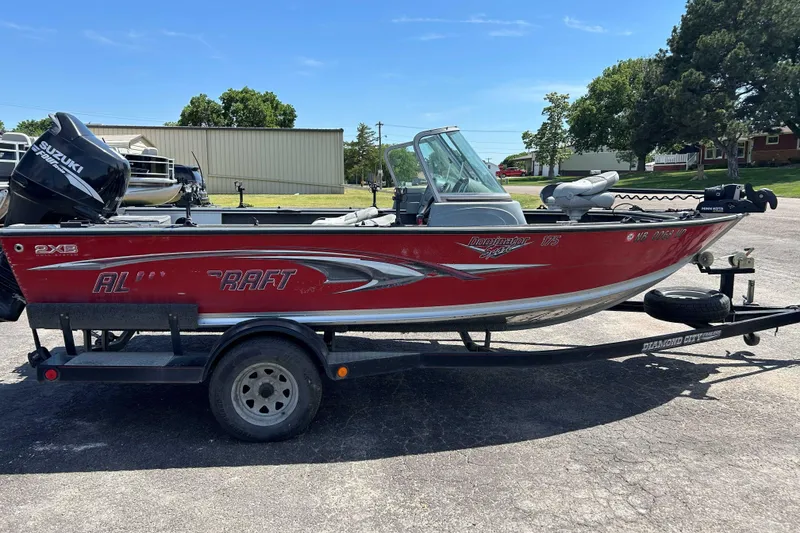 Slide: The Image of 2007 Alumacraft Dominator 175 Sport boat on trailer, red exterior, Suzuki motor. - 10