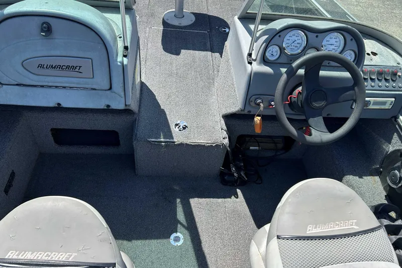 Slide: The Image of 2007 Alumacraft Dominator 175 Sport boat interior with steering wheel and dashboard controls. - 5
