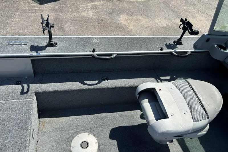 Slide: The Image of 2007 Alumacraft Dominator 175 Sport interior with fishing rod holders and seating. - 7