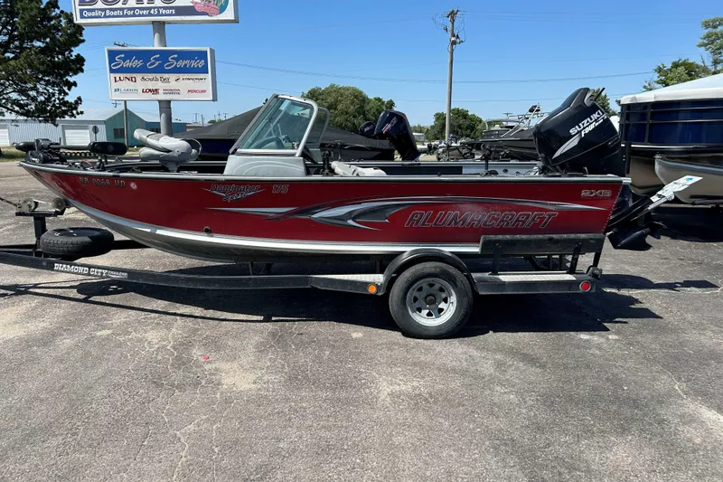 Slide: The Image of 2007 Alumacraft Dominator 175 Sport boat on trailer, parked outdoors. - 8