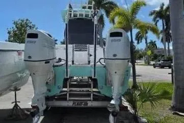 Slide: The Image of 2023 Twin Vee 240 GFX CC boat with dual outboard engines. - 4