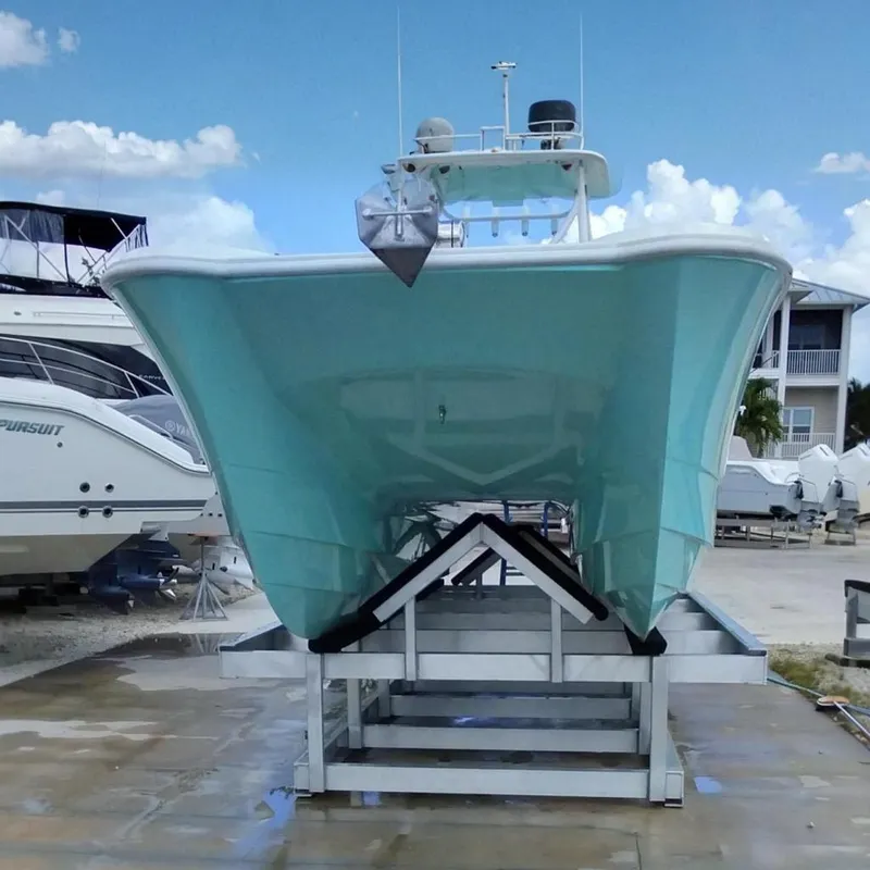 Slide: The Image of 2023 Twin Vee 240 GFX CC boat on a trailer at the marina. - 2