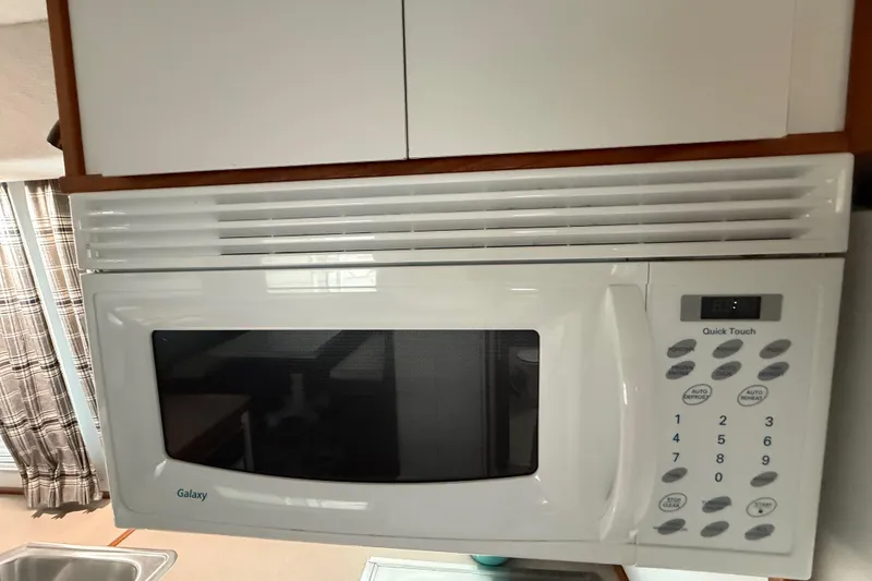 Slide: The Image of White Galaxy microwave with digital controls in a 1995 Harbor Master 52 Wide Body kitchen. - 15