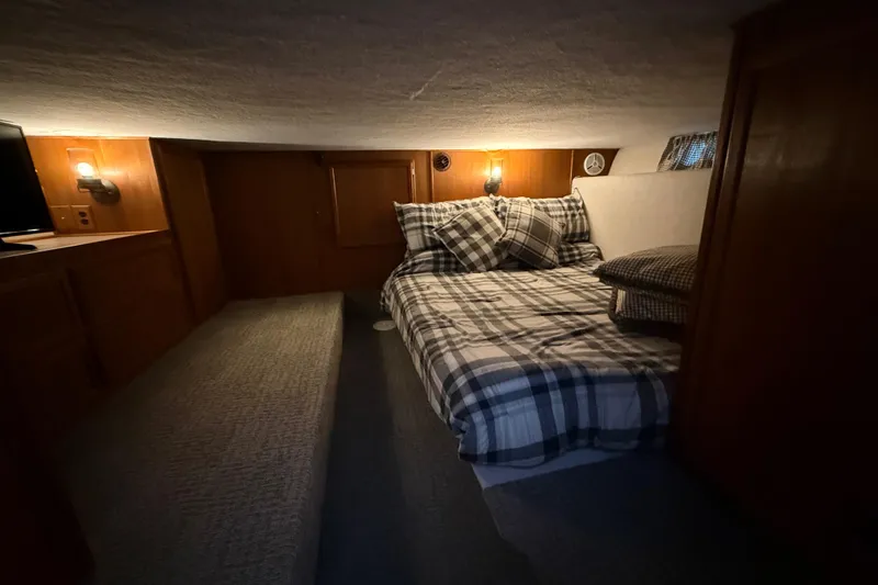 Slide: The Image of Cozy bedroom in 1995 Harbor Master 52 Wide Body houseboat with plaid bedding and warm lighting. - 22