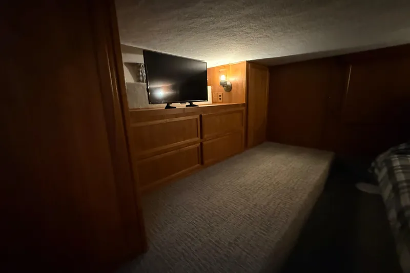 Slide: The Image of Cozy interior of 1995 Harbor Master 52 Wide Body with TV and wooden cabinetry. - 23