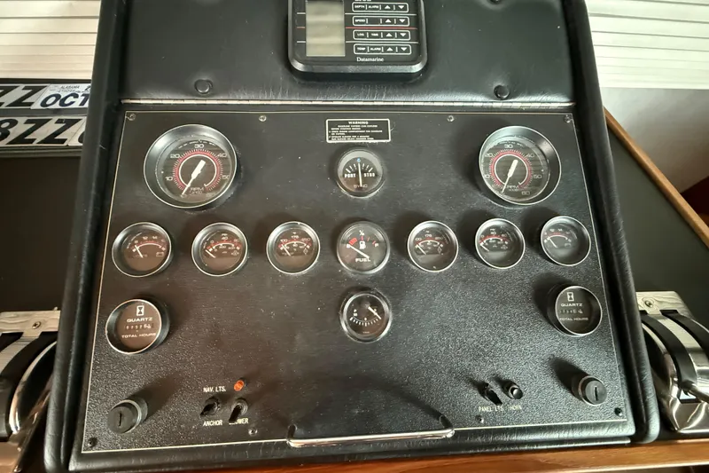 Slide: The Image of Control panel of a 1995 Harbor Master 52 Wide Body boat with gauges and switches. - 26