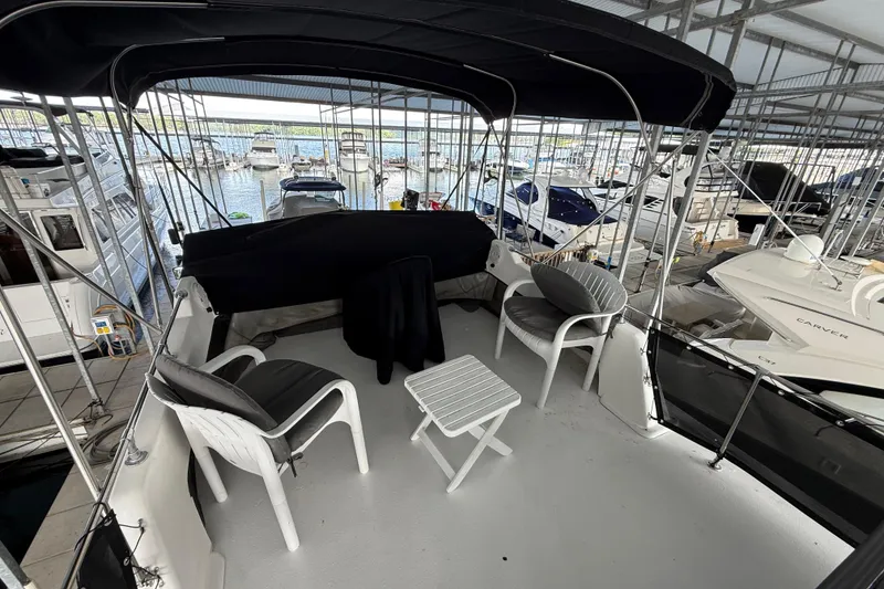 Slide: The Image of 1995 Harbor Master 52 Wide Body yacht interior with seating area and marina view. - 7