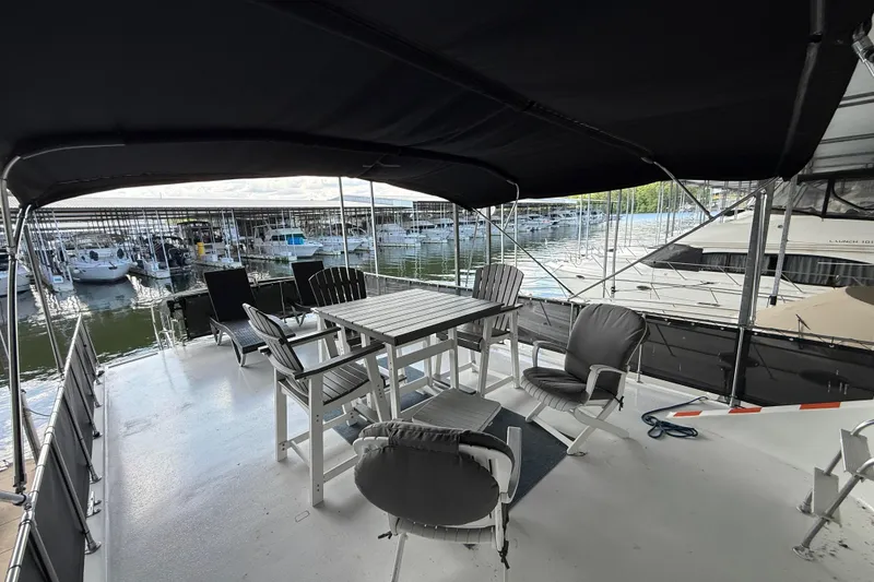 Slide: The Image of Spacious deck of 1995 Harbor Master 52 Wide Body yacht with seating, docked at marina. - 8