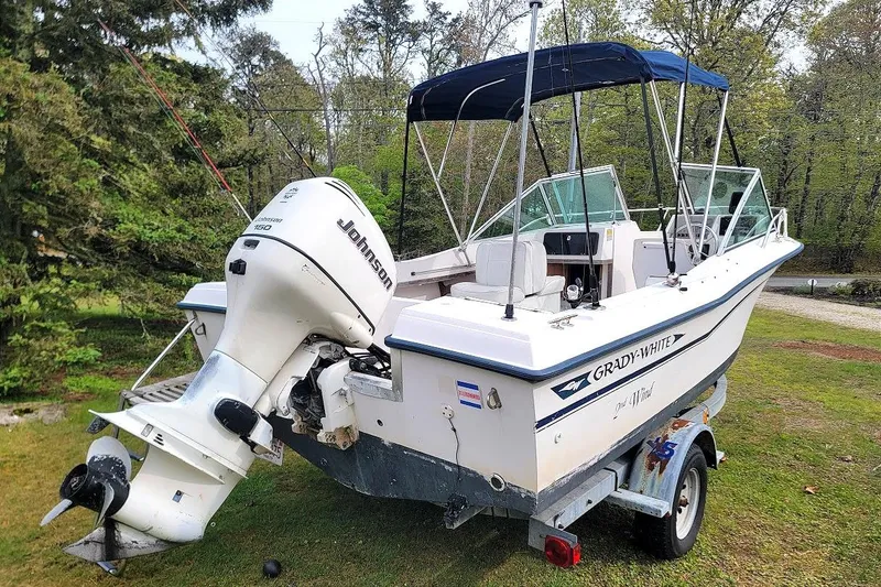 Slide: The Image of 1988 Grady-White Freedom 192 boat with Johnson 150 outboard motor on trailer. - 11