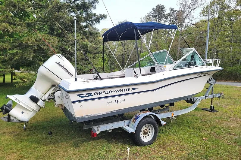 Slide: The Image of 1988 Grady-White Freedom 192 boat on trailer with Johnson outboard motor. - 12