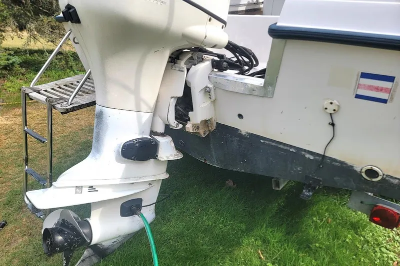 Slide: The Image of 1988 Grady-White Freedom 192 boat engine and stern, parked on grass. - 13