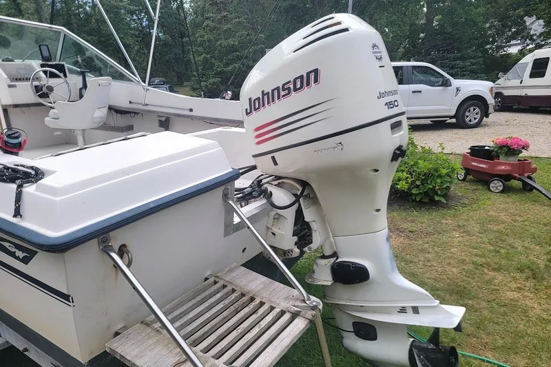 Slide: The Image of 1988 Grady-White Freedom 192 boat with Johnson 150 outboard motor, parked outdoors. - 14