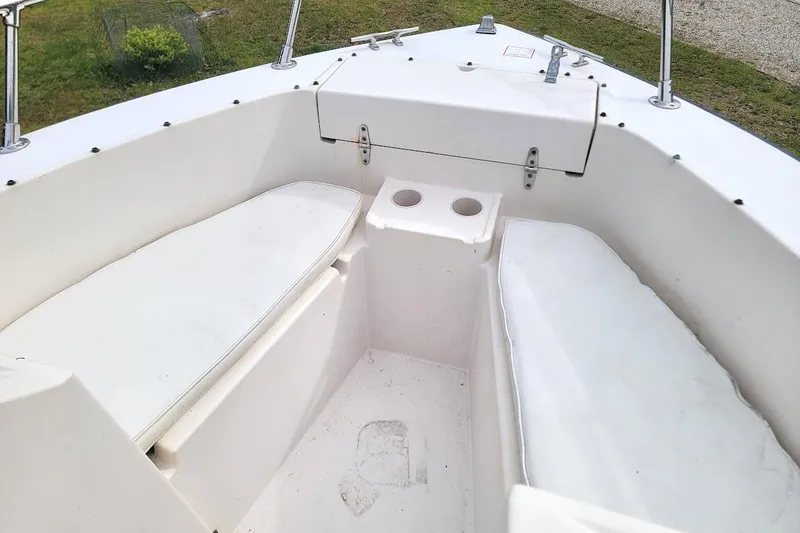 Slide: The Image of 1988 Grady-White Freedom 192 boat interior with white seating and cup holders. - 4