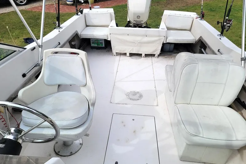 Slide: The Image of 1988 Grady-White Freedom 192 boat interior with white seating and steering wheel. - 5