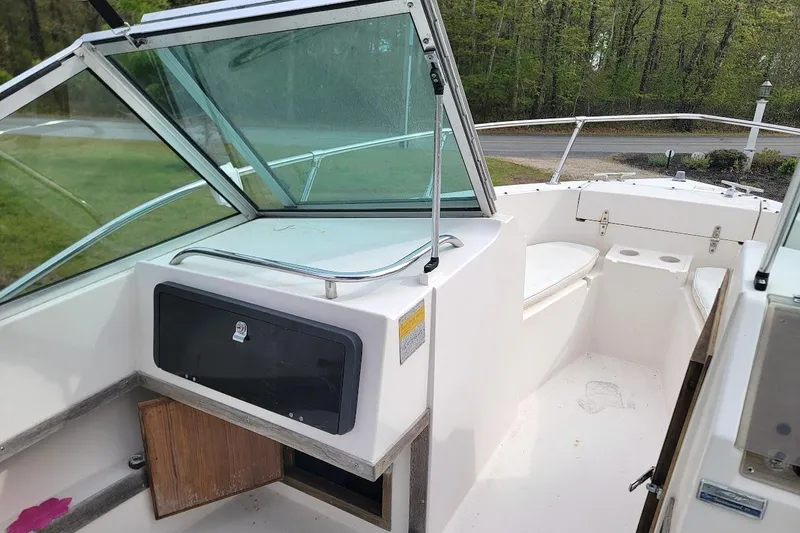 Slide: The Image of 1988 Grady-White Freedom 192 boat interior with seating and storage compartments. - 6