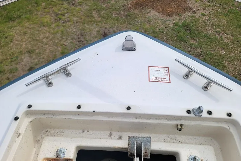 Slide: The Image of Bow of 1988 Grady-White Freedom 192 boat with cleats and hatch, on grass. - 7