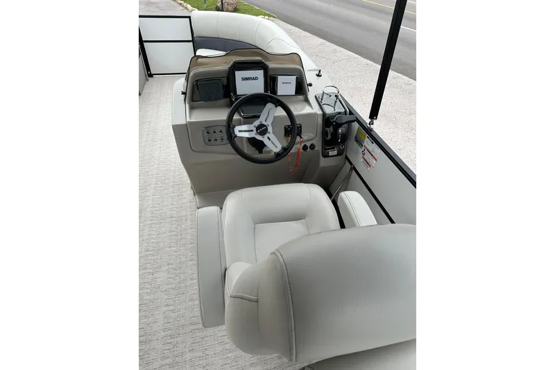 Slide: The Image of Interior view of 2021 Xcursion 223 RFX boat with steering console and seating. - 3