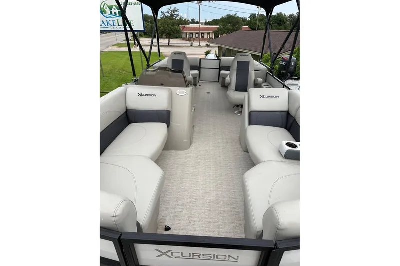 Slide: The Image of 2021 Xcursion 223 RFX pontoon boat interior with spacious seating and modern design. - 4