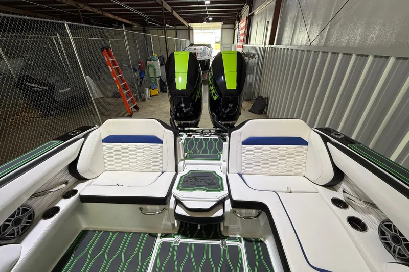 Slide: The Image of 2024 Sunsation 32 CCX boat interior with stylish seating and dual outboard motors. - 14