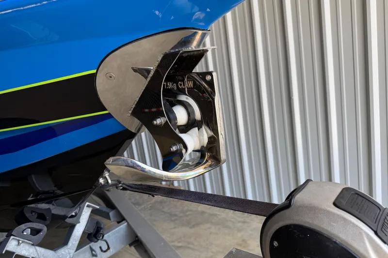 Slide: The Image of 2024 Sunsation 32 CCX boat anchor detail with blue and black hull design. - 15