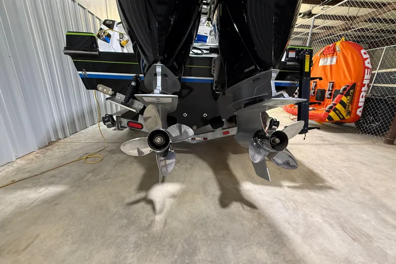 Slide: The Image of 2024 Sunsation 32 CCX boat propellers in a storage area with an inflatable tube nearby. - 3
