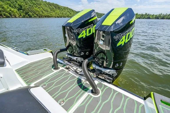 Slide: The Image of 2024 Sunsation 32 CCX boat with twin Racing 400 engines on a scenic lake. - 30