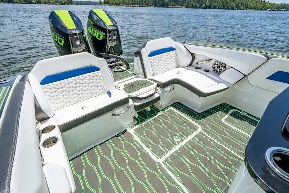 Slide: The Image of 2024 Sunsation 32 CCX boat interior with stylish seating and twin outboard engines on a lake. - 31