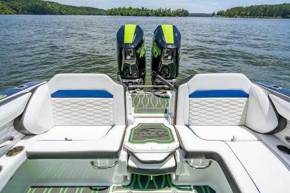 Slide: The Image of 2024 Sunsation 32 CCX boat with dual engines, luxurious seating, and scenic lake view. - 33