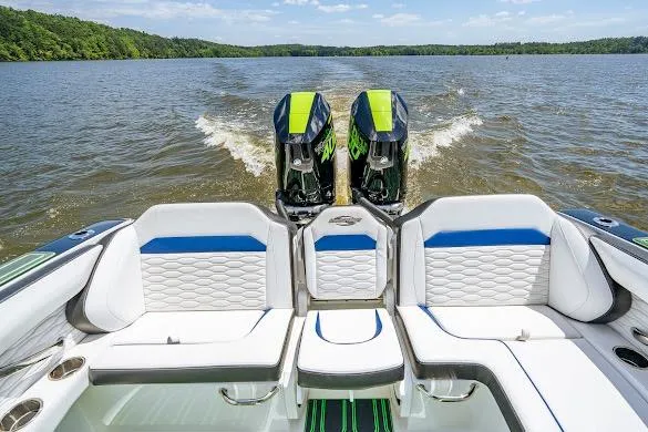 Slide: The Image of 2024 Sunsation 32 CCX boat with dual engines on a lake, featuring luxurious seating. - 38