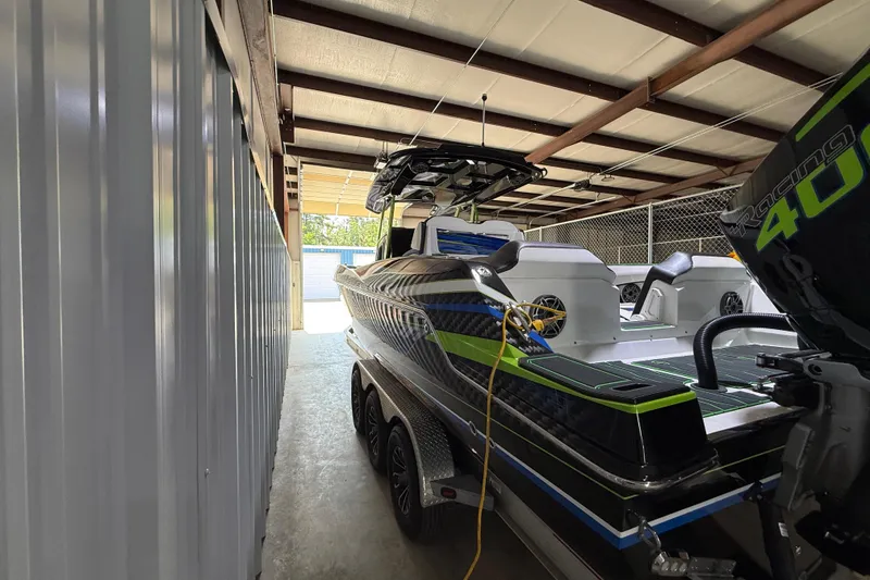 Slide: The Image of 2024 Sunsation 32 CCX boat in storage, featuring sleek design and powerful engine. - 4