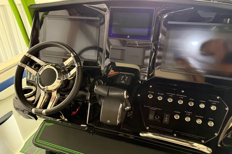 Slide: The Image of 2024 Sunsation 32 CCX dashboard with steering wheel, dual screens, and control panel. - 5