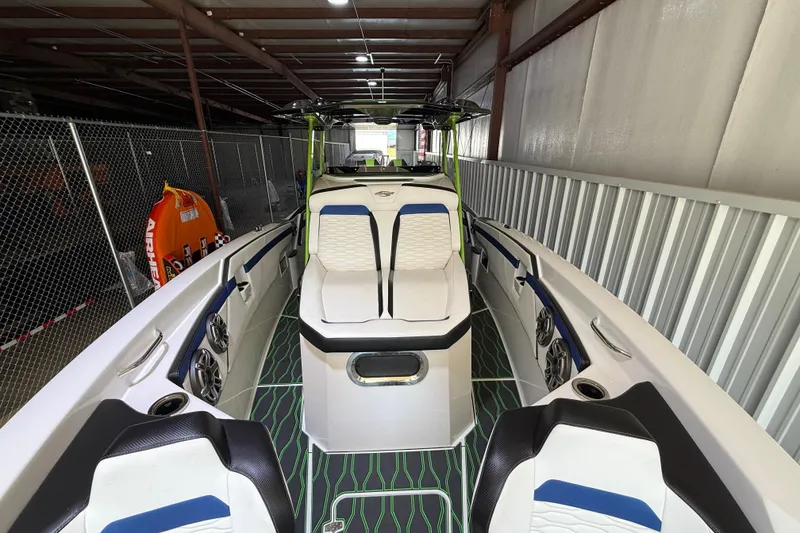Slide: The Image of 2024 Sunsation 32 CCX boat interior with modern seating and sleek design in storage. - 7