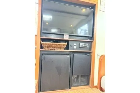 Slide: The Image of Entertainment center in 2006 Endeavour 44 TrawlerCat with TV, stereo, and storage compartments. - 12