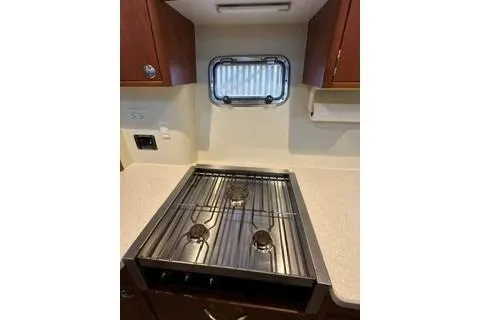 Slide: The Image of 2006 Endeavour 44 TrawlerCat kitchen with a three-burner stove and compact window. - 15