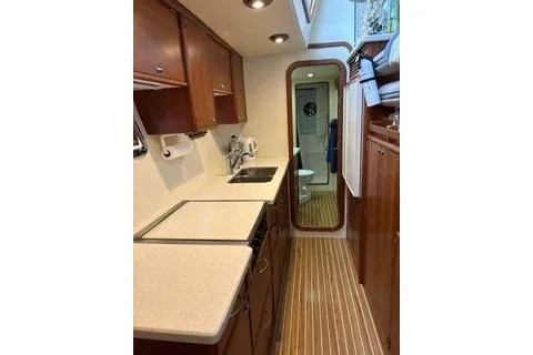 Slide: The Image of 2006 Endeavour 44 TrawlerCat galley with wood cabinetry, modern appliances, and sleek countertops. - 17