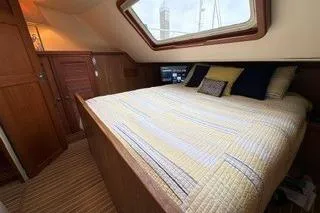 Slide: The Image of 2006 Endeavour 44 TrawlerCat cabin with cozy bed and nautical decor. - 19